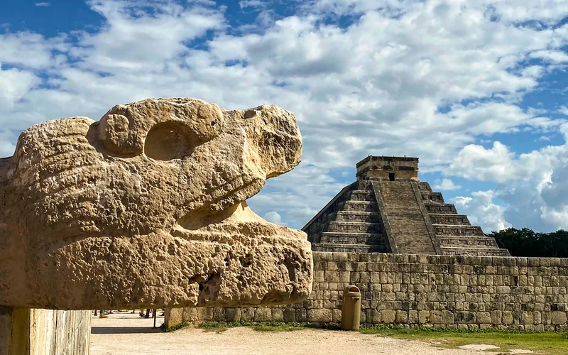 Serpent head sculpture beside the pyramid at Chichén Itzá